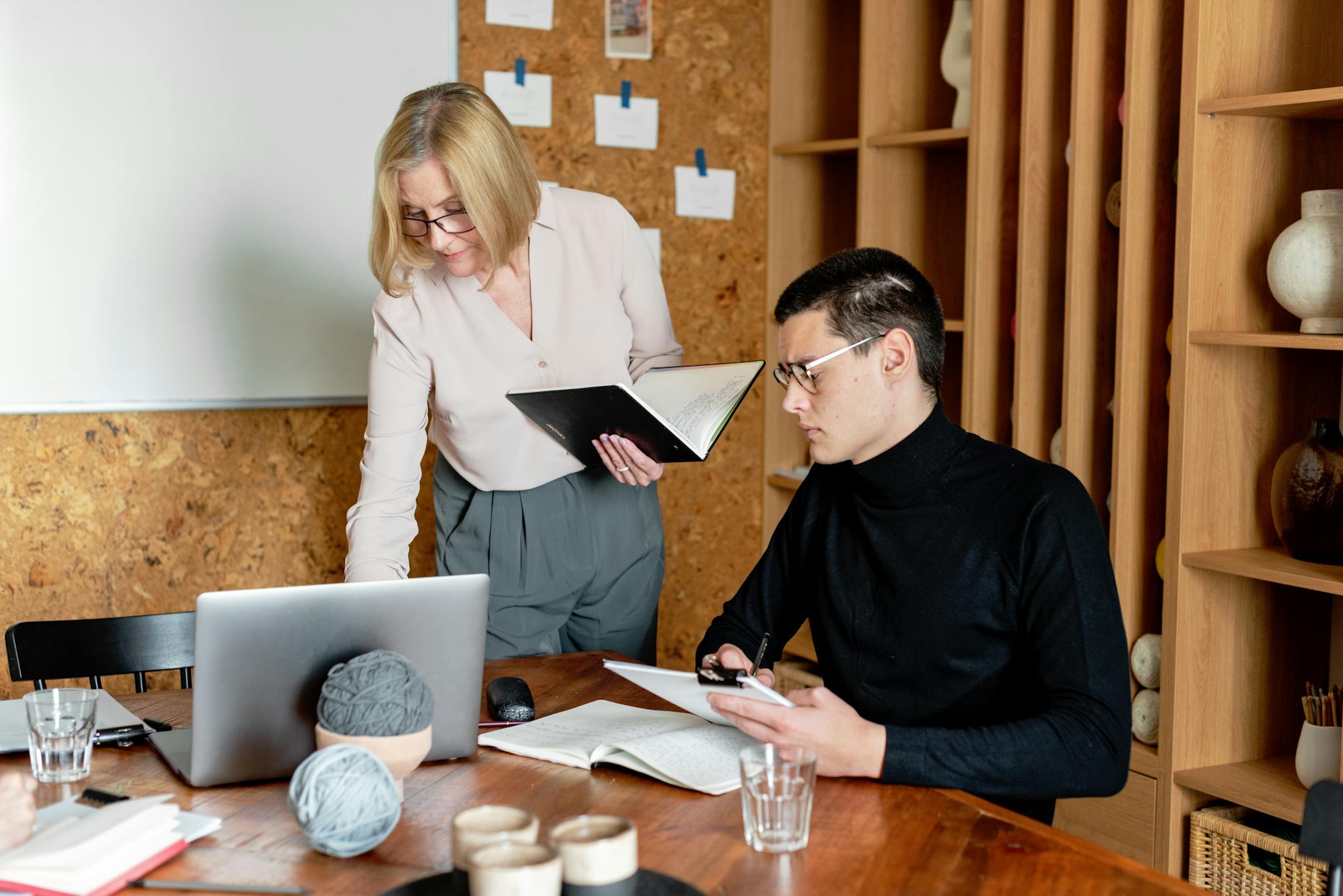 Professional teamwork in an office as colleagues discuss and take notes.